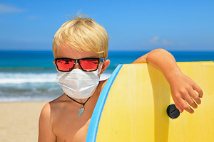 Young surfer wearing face mask stock photo containing coronavirus and corona