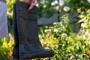 Hand Holding Garden Boots, a Person Photo by Ales Munt