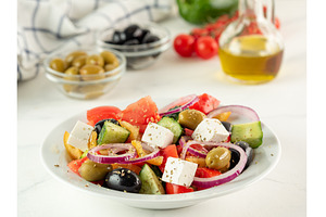 Greek salad on white table, a Food & Drink Photo by Fascinadora