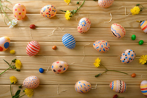 Scattered Colorful Easter Eggs on Wooden Background, a Holiday Photo by Davizro's Market