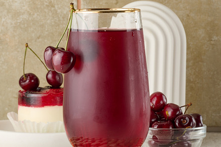 Cherry juice in a transparent glass and fresh cherries on a whit, a Food & Drink Photo by ndanko