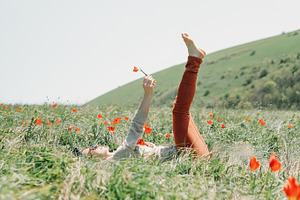 Woman relaxing on flower field.