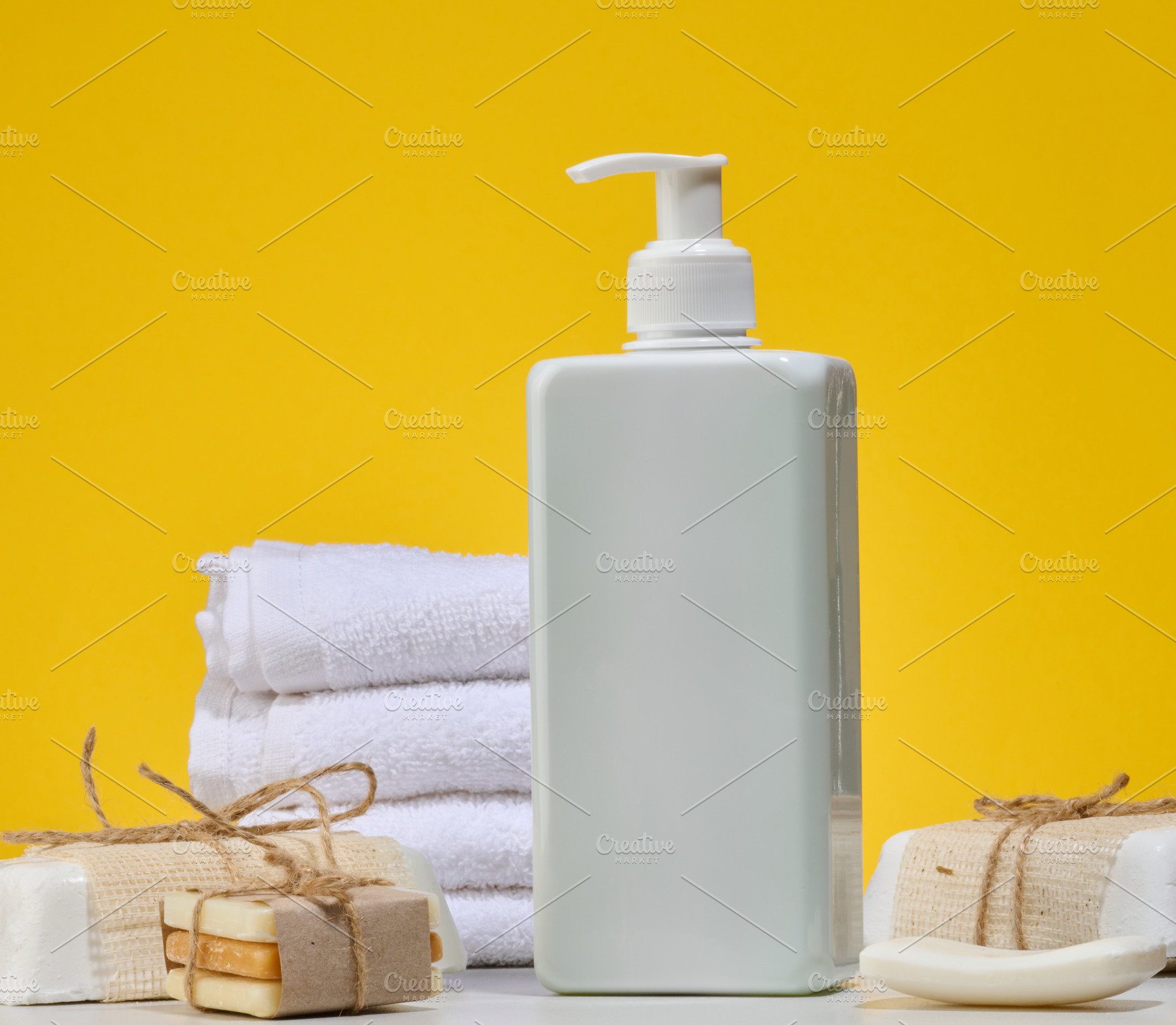 White square bottle with dispenser and stack of folded white tow, a Beauty & Fashion Photo by ndanko