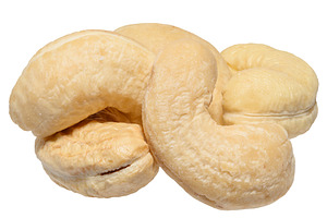 Heap of peeled cashew nuts on isolated background, close up, a Food & Drink Photo by ndanko