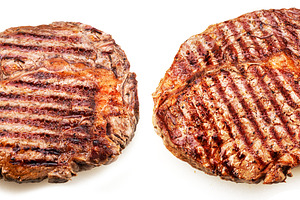 Two grilled ribeye steaks isolated on white background., a Food & Drink Photo by Volff