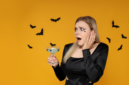 Concept of Halloween, young woman on yellow background, a Person Photo by AtlasStudio PRO
