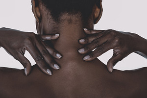 African woman with neck ache