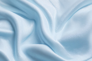 Light blue flowing fabric creating soft elegant waves and a smoo, a Photo by Studio ANNA