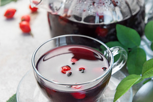 Rosehip tea brewing in glass teapot and cup with fresh rose hips, a Food & Drink Photo by Olena Rudo