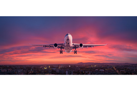 Airplane is flying in colorful sky, a Transportation Photo by den-belitsky
