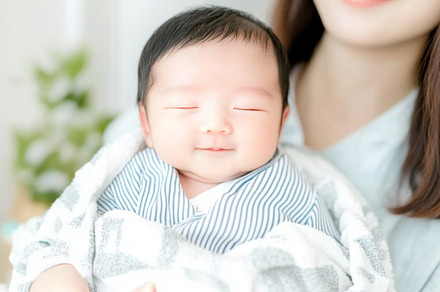 Newborn korean baby in arms of mother