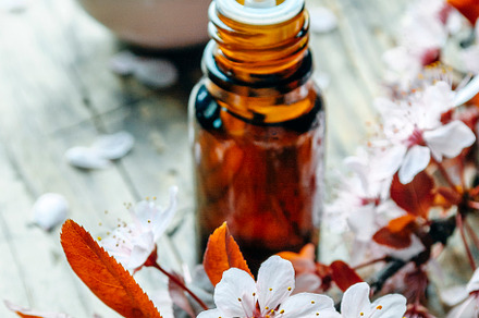 Essential massage oil with flower on, a Health & Medical Photo by hitdelight