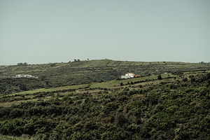 Green hills with distant farmhouse, an Architecture Photo by SkyNext