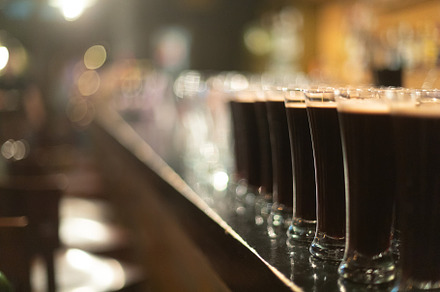 Beer glasses with dark beer are on t containing beer, glass, and alcohol, a Food & Drink Photo by oleghz