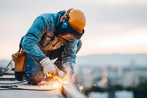 Construction Worker Welding on Rooftop, an Industrial Photo by AlyaAnd