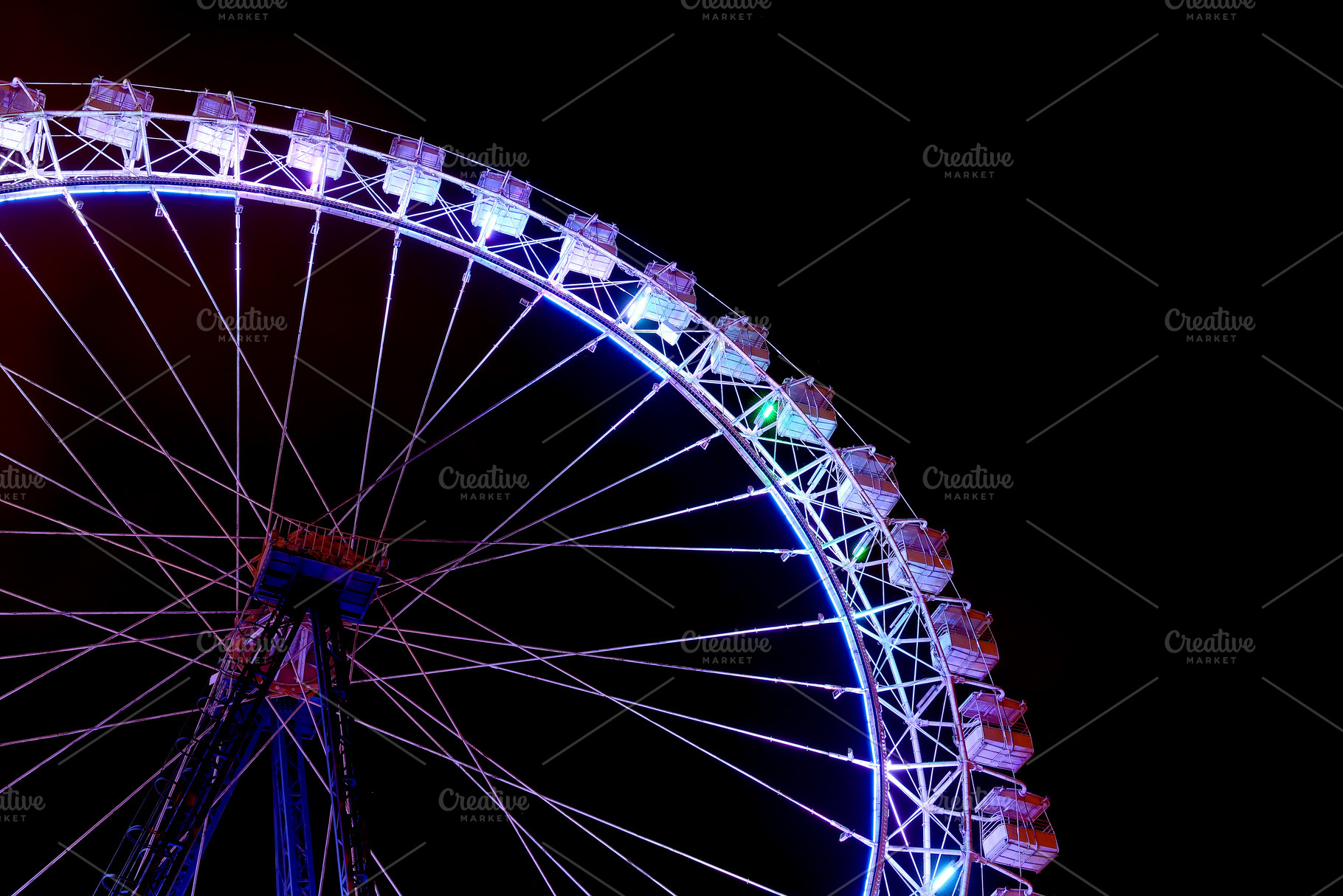 Part of ferris wheel with blue light containing ferris wheel, night, and wheel, a Holiday Photo by FedotovAnatoly