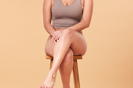 Portrait, beauty and an asian woman on a chair in studio on a beige background for natural body positivity. Model, underwear and an attractive young female sitting on a stool with confidence, a Photo by Peopleimages.com