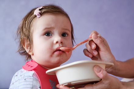 One year old baby girl eating soup. Mother gives baby food from a spoon., a Person Photo by Rohan Photography