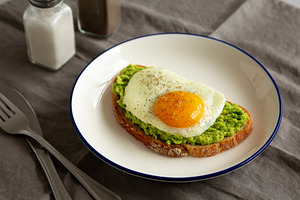 Homemade Avocado Toast with Egg on a Plate, side view. Close-up., a Food & Drink Photo by LiudmylaChuhunova