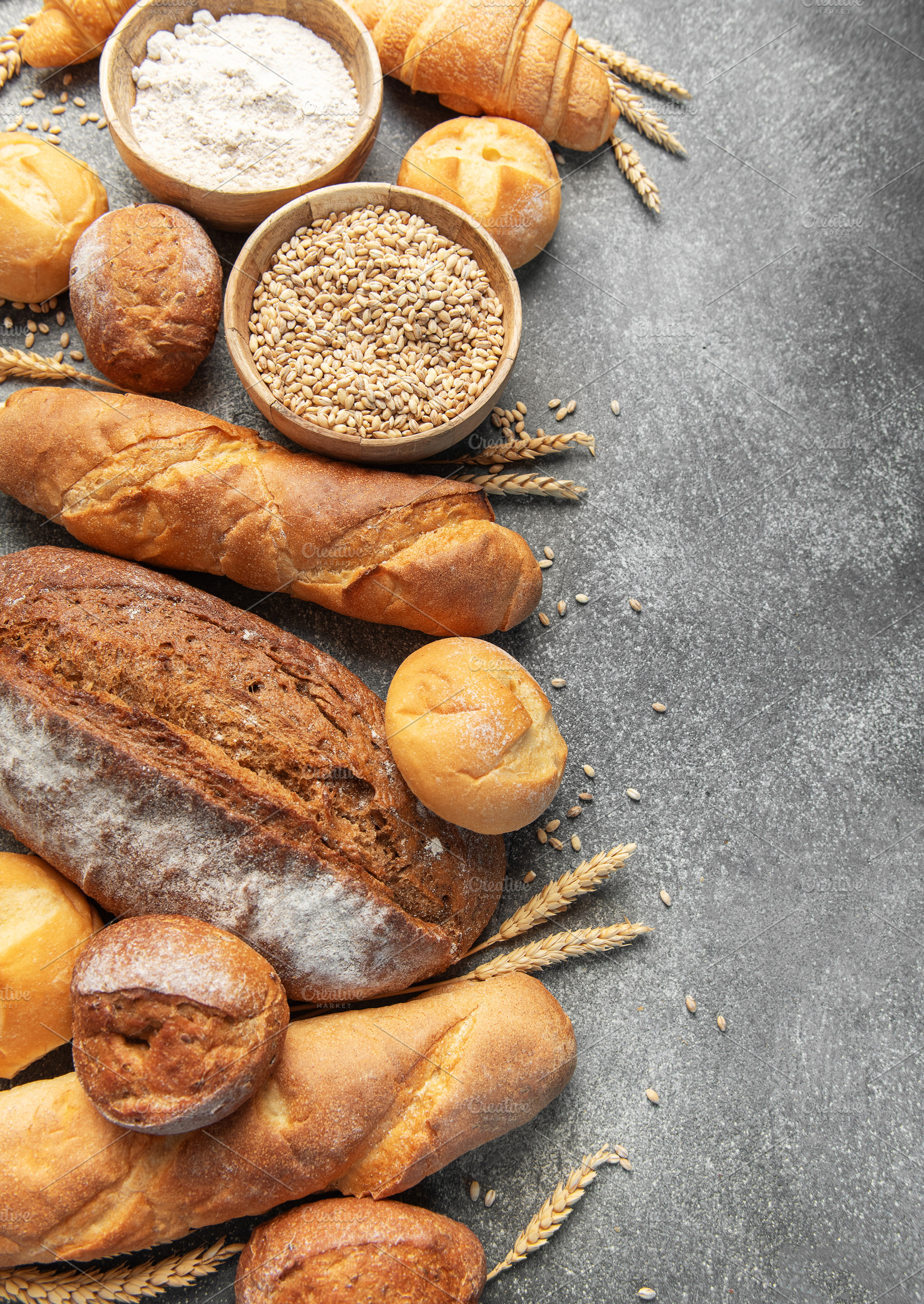 Assortment of fresh baked bread, grain, and flour, a Food & Drink Photo by Olena Rudo