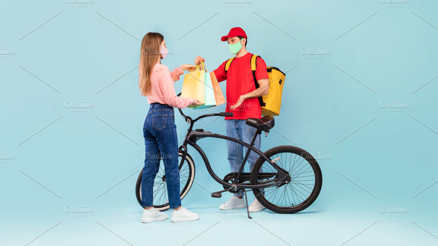 Deliveryman Giving Bags To Woman Delivering Parcel On Blue Background, a Photo by Prostock-Studio
