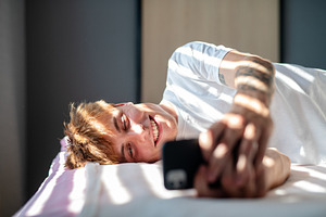 Man in love texting to his partner., a School & Education Photo by HalfPoint
