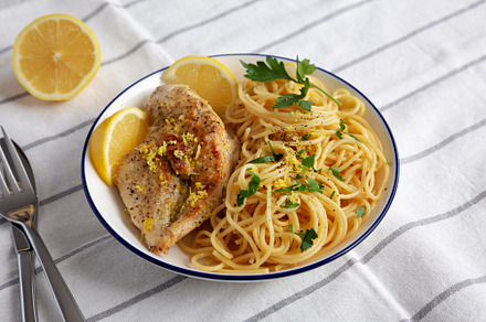 Homemade Lemon Pepper Chicken with Pasta on a Plate, side view., a Food & Drink Photo by LiudmylaChuhunova