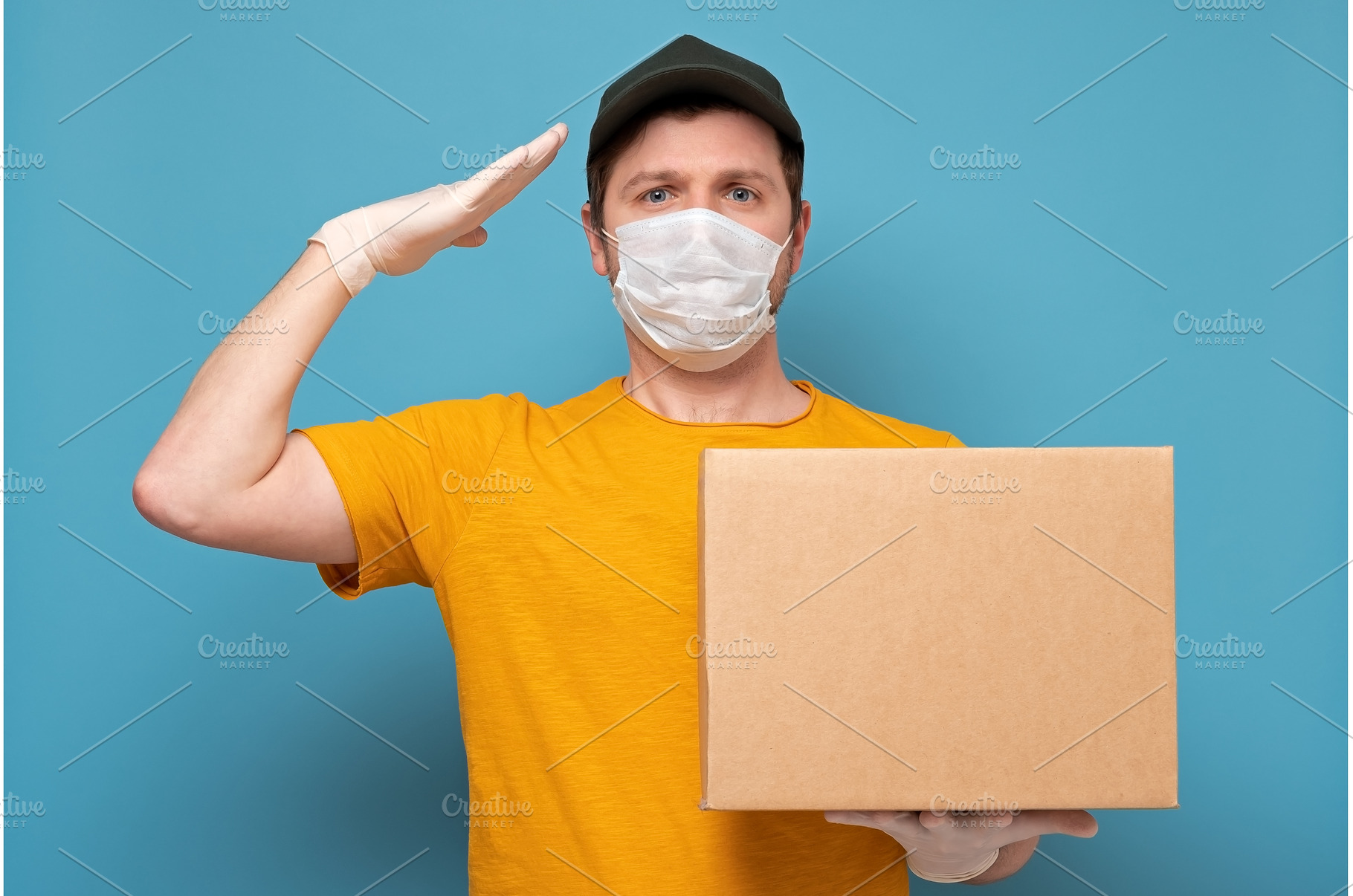Young delivery man in medical mask, a Person Photo by Koldunova