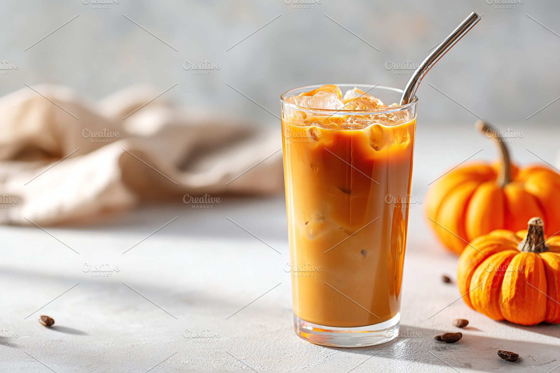 Enjoying a refreshing iced pumpkin beverage in a cozy autumn setting, a Photo by AlyaAnd