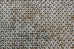 Worn diamond plate metal with rust featuring equipment, texture, and abstract