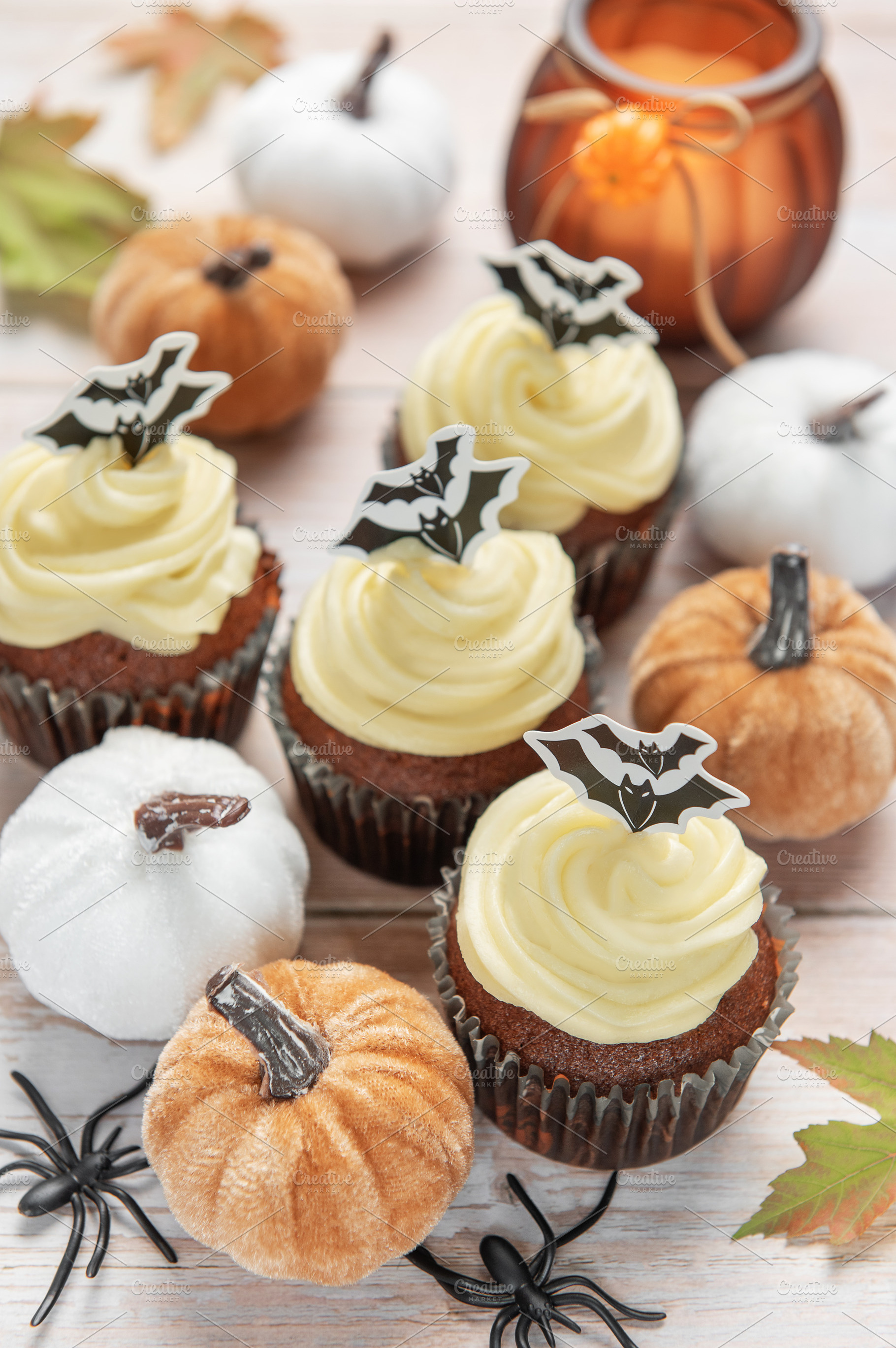 Halloween inviting celebration with themed cupcakes and pumpkins, a Food & Drink Photo by Olena Rudo