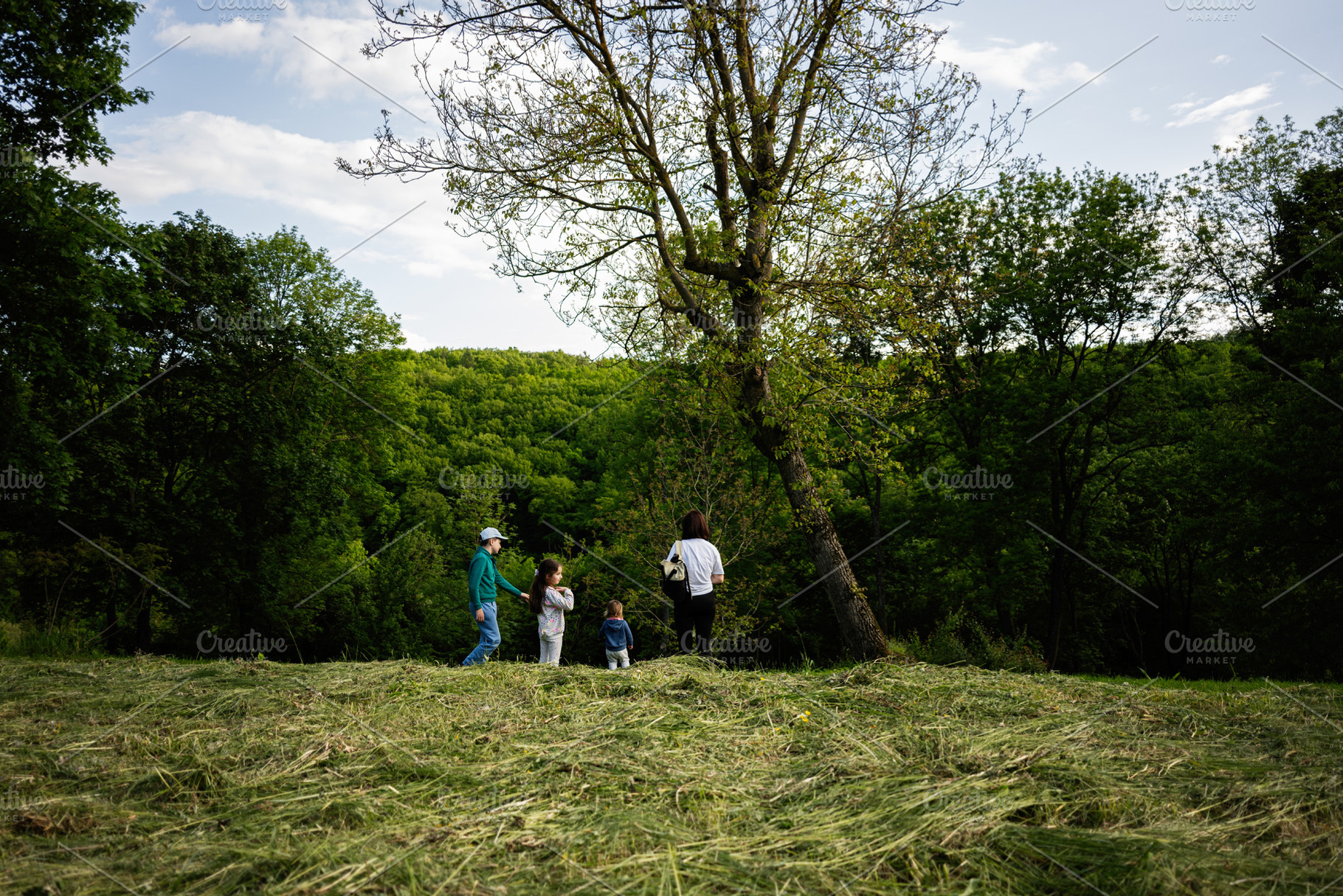 A group enjoying nature together in a scenic forest clearing, a Person Photo by AS photostudio