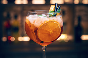 Orange cocktail with ice and mint, a Photo by Grafvision photography