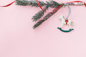 Horse christmas toy on pink flat lay with golden star, bauble an, a Holiday Photo by Sonjachni