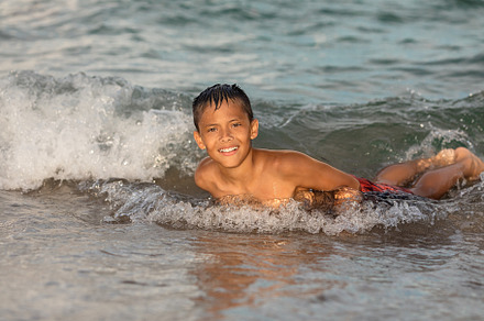 Happy boy swimming in ocean, Florida