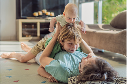 Father, son, and newborn baby lying