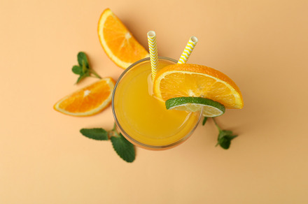 Tequila sunrise cocktail and ingredients on beige background, a Food & Drink Photo by AtlasStudio PRO