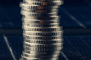 A tall stack of silver metal coins on a dark background, concept, a Business Photo by ndanko