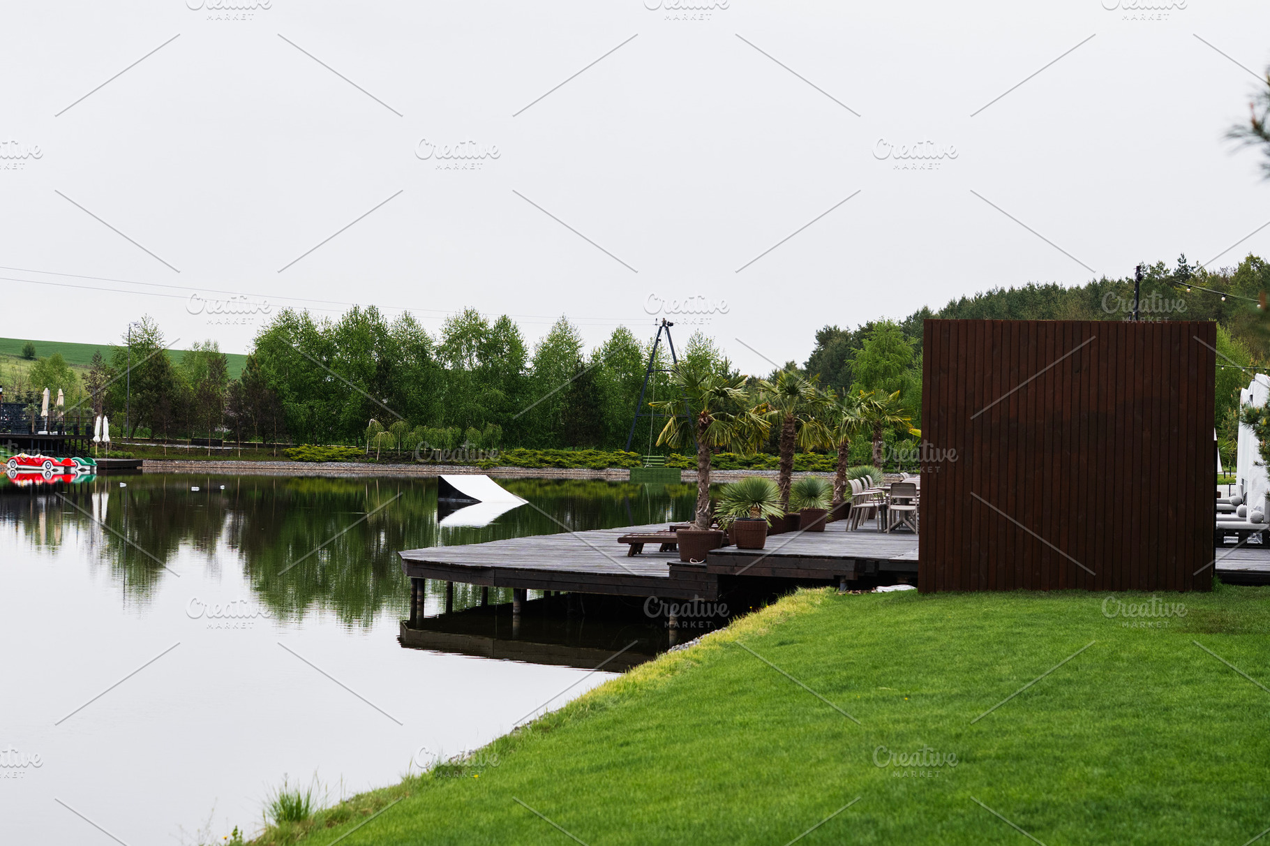 Tranquil lakeside scene with wooden deck and beautiful serene surroundings, a Photo by AS photostudio