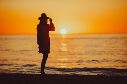 Young happy woman on the beach enjoy her summer vacation. Beautiful woman in ha, a Person Photo by travnikovstudio