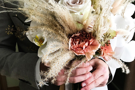 Elegant groom holding beautiful rustic wedding bouquet, a Photo by AS photostudio