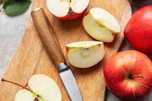 Fresh red apples and slices with knife on wooden cutting board, a Food & Drink Photo by Olena Rudo