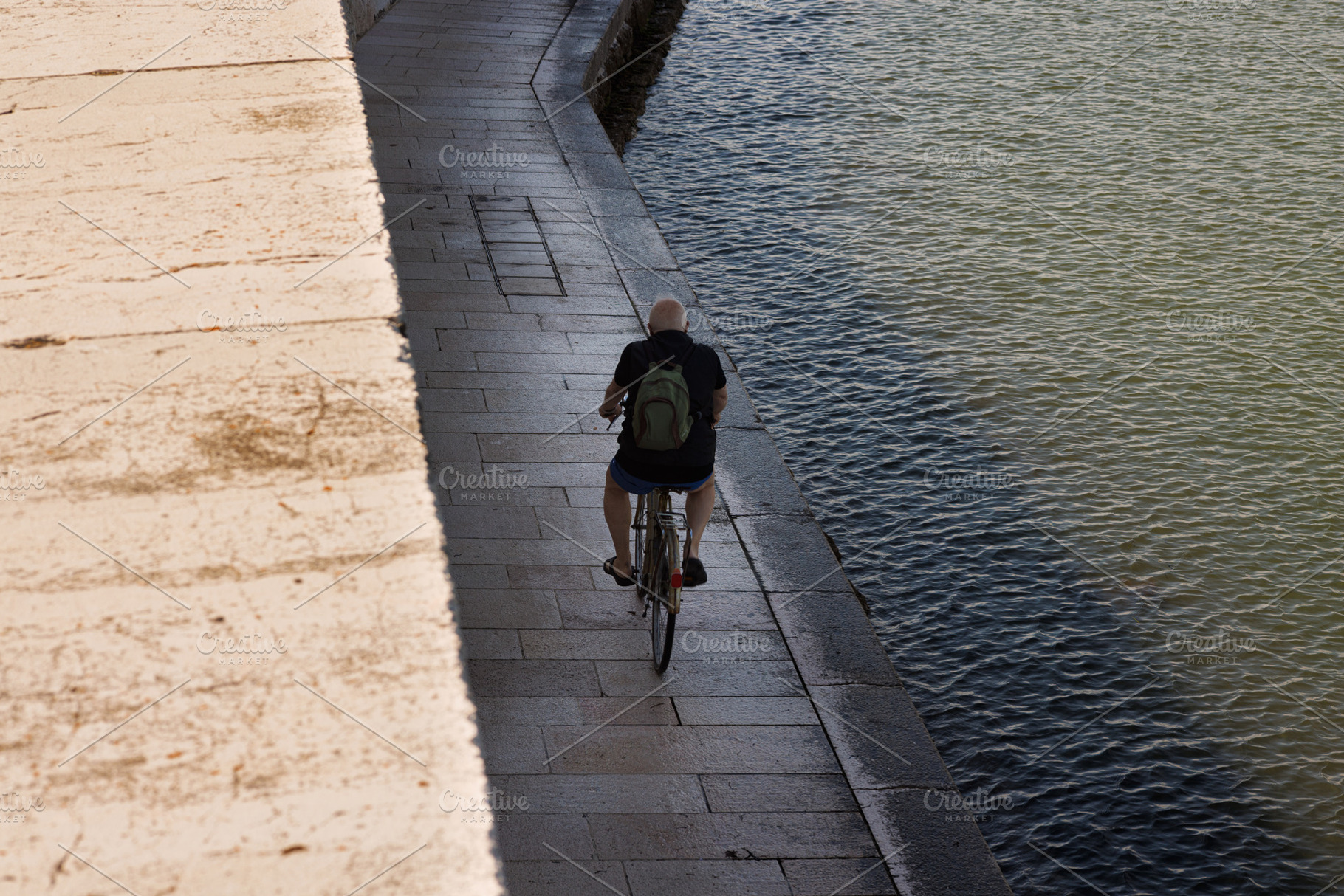 Old man riding bike in Pellestrina Island, a Transportation Photo by Bepslabor