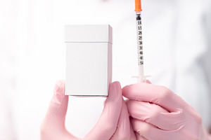 Anonymous cosmetologist holding injection syringe and medicine box, a Photo by andreonegin market