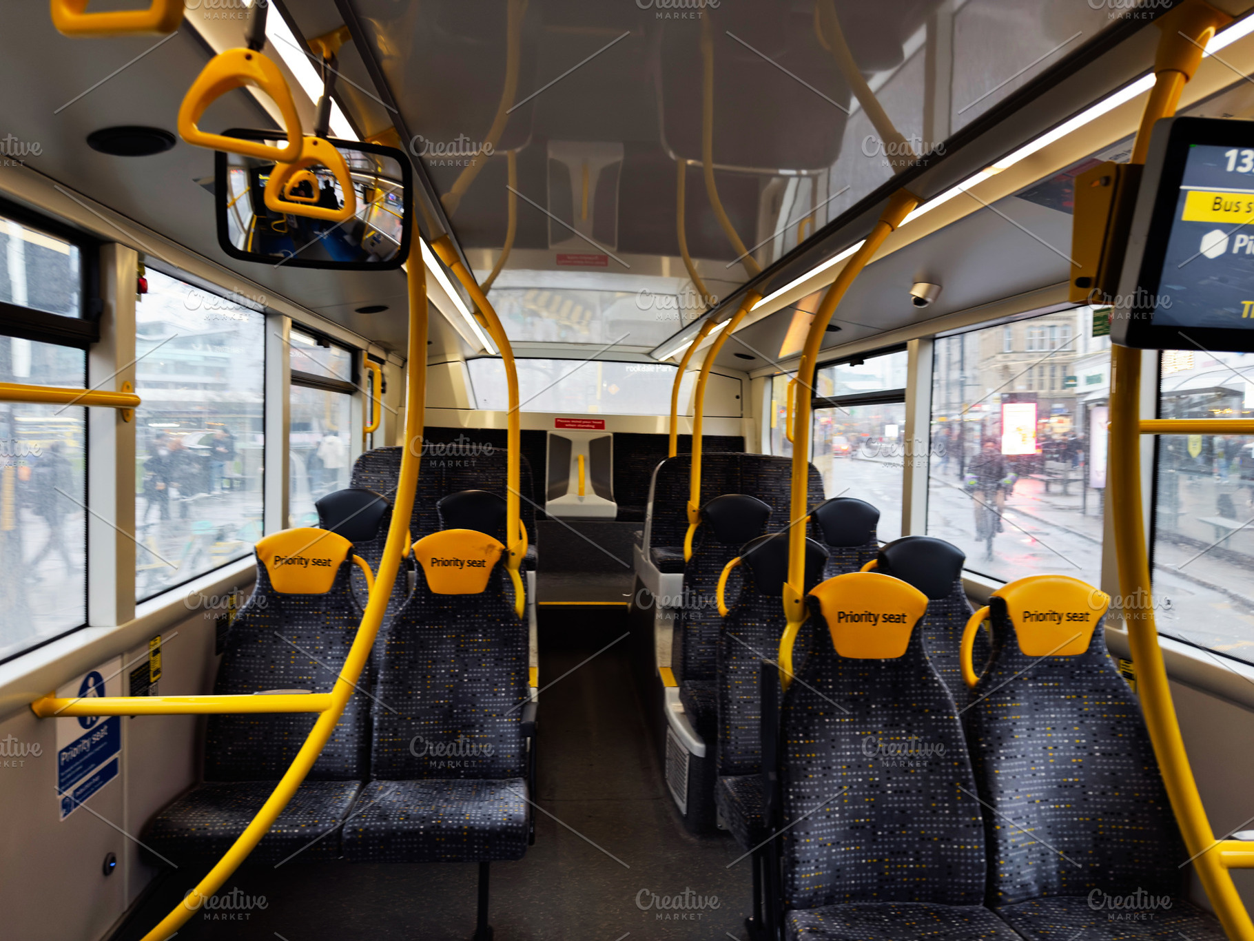Bus interior with yellow priority seats and bright handrails in a modern urban, a Photo by AS photostudio