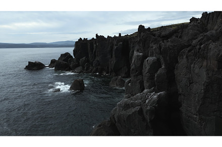 Top view of black rocks of sea coast, a Nature Photo by Media Whale Stock