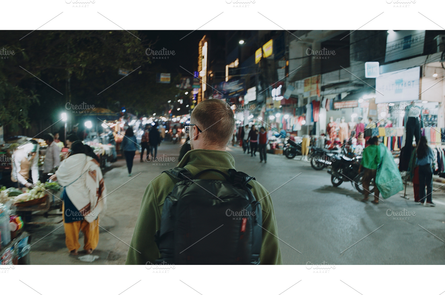 backpacker exploring night market, a Person Photo by Our Amazing World