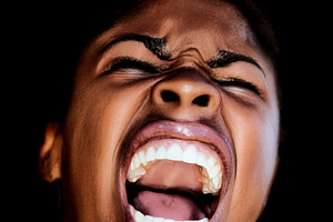 Shaved black woman with an angry expression, a Photo by DanFLCreativo