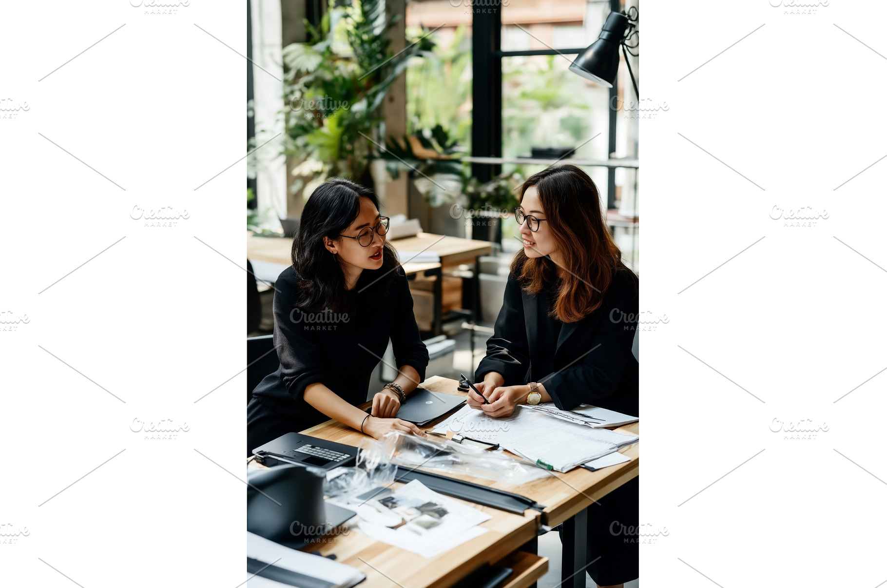 Two Asian businesswomen discussing a, a Person Photo by Sergey Kotenev