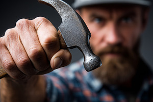 Handyman holding a hammer, an Industrial Photo by MistyDay